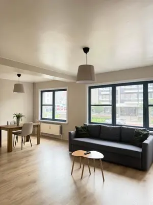 a living room with a couch and a table at Appartement Brussels Expo II in Grimbergen