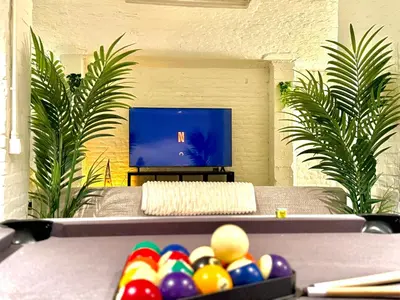 a table with balls in front of a tv at Spacious BXL Loft in Brussels