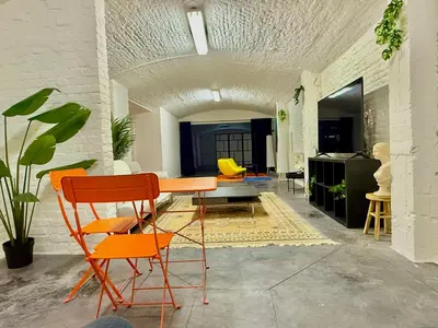 a room with a table and chairs in a room at Spacious BXL Loft in Brussels