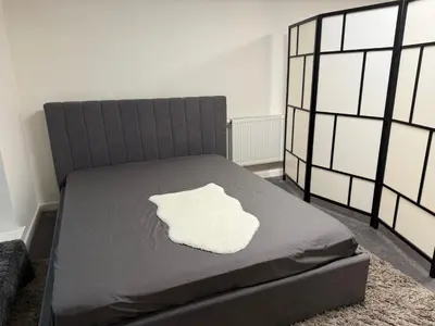 a bedroom with a bed with a white pillow on it at Spacious BXL Loft in Brussels