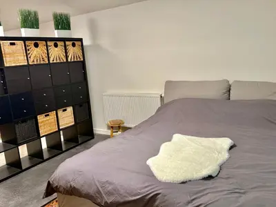 a bedroom with a bed with a white pillow on it at Spacious BXL Loft in Brussels