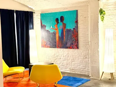 a living room with a painting on the wall at Spacious BXL Loft in Brussels