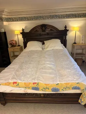 a large bed in a bedroom with two night stands at Charming apartment in Antwerp in Antwerp