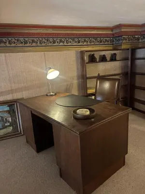an office with a desk with a lamp and a chair at Charming apartment in Antwerp in Antwerp