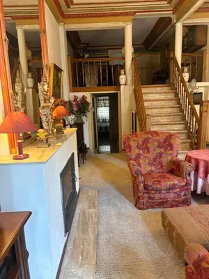 a living room with a fireplace and a chair at Charming apartment in Antwerp in Antwerp