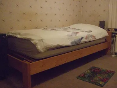 a bed sitting on a wooden platform in a room at Bij het station van Drongen in Ghent