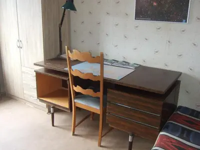 a wooden desk with a chair and a desk with a desk at Bij het station van Drongen in Ghent