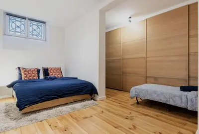a bedroom with a bed and a bench in it at Cosy EU Apartment - Central, Parking, Terrace in Brussels