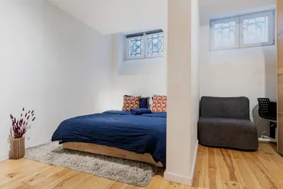 a bedroom with a bed and a chair at Cosy EU Apartment - Central, Parking, Terrace in Brussels