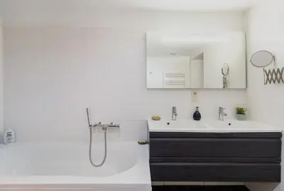 a bathroom with a sink and a tub and a shower at Cosy EU Apartment - Central, Parking, Terrace in Brussels