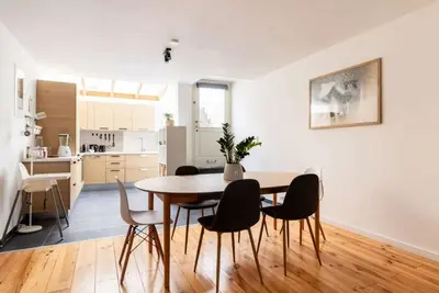 a kitchen and dining room with a table and chairs at Cosy EU Apartment - Central, Parking, Terrace in Brussels
