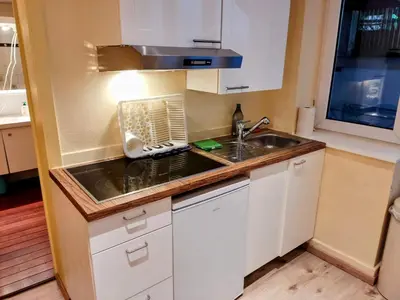 a small kitchen with a sink and a microwave at Modern half-basement 1BR near Montgomery & VUB in Brussels