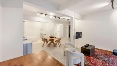 a living room with a table and chairs at Modern loft near City Centre, Nomade CasaMia in Antwerp