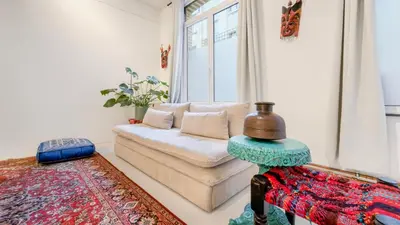 a living room with a couch and a window at Modern loft near City Centre, Nomade CasaMia in Antwerp
