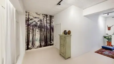 a hallway with a painting of trees on the wall at Modern loft near City Centre, Nomade CasaMia in Antwerp