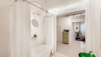 a white bathroom with a shower and a toilet at Modern loft near City Centre, Nomade CasaMia in Antwerp