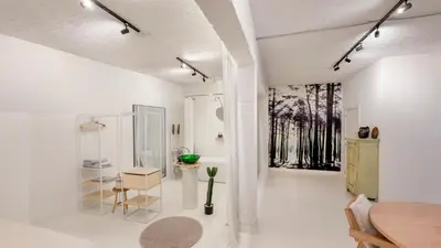 a white room with a table and a window at Modern loft near City Centre, Nomade CasaMia in Antwerp