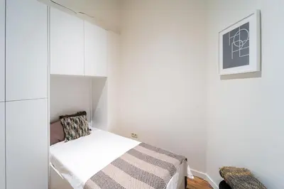 a small room with a bed and a cabinet at Spacious 7-Person House in the Heart of Antwerp in Antwerp
