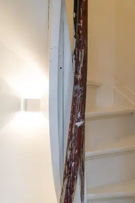 a surfboard is leaning against a wall at Spacious 7-Person House in the Heart of Antwerp in Antwerp