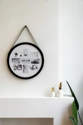 a black and white mirror on a white wall at Spacious 7-Person House in the Heart of Antwerp in Antwerp
