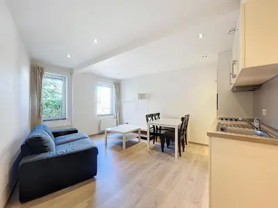 a living room with a couch and a table at kazernestraat app 101 in Ghent