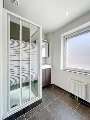a bathroom with a large window and a sink at kazernestraat app 101 in Ghent