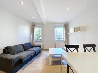 a living room with a couch and a table at kazernestraat app 101 in Ghent