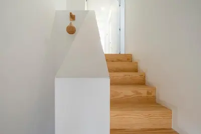 a staircase in a house with white walls and wooden floors at Brussels Louise Design residence in Brussels