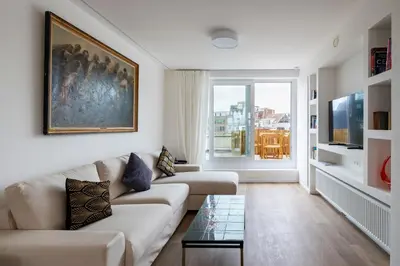 a living room with a couch and a table at Brussels Louise Design residence in Brussels