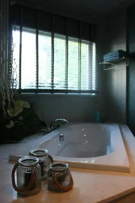 a bath tub with three jars on top of it at Casa Lucinda in Ghent