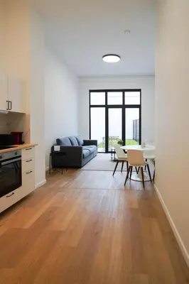 a living room with a couch and a table at Appartment St guidon 1 in Brussels