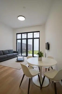 a living room with a table and chairs and a couch at Appartment Vaillance 2 in Brussels