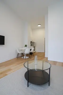 a living room with a glass table and chairs at Appartment Vaillance 2 in Brussels