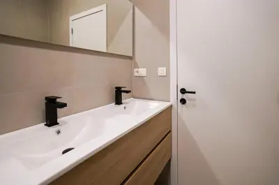 a bathroom with a white sink and a mirror at Appartment Wayez 3 in Brussels