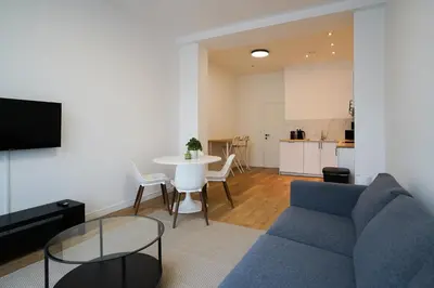 a living room with a blue couch and a table at Appartment Astrid 4 in Brussels