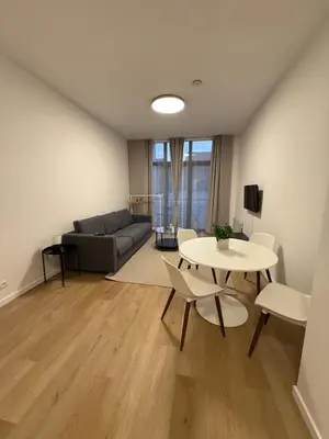 a living room with a couch and a table and chairs at Appartment Astrid 4 in Brussels