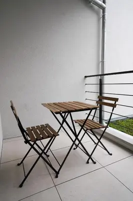 a picnic table and two chairs sitting next to a window at Appartment Astrid 4 in Brussels