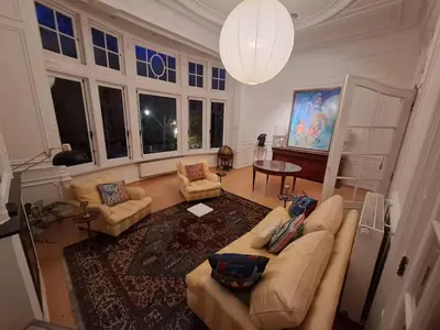 an overhead view of a living room with a couch and chairs at Brussels' Premier Parkside Residence in Brussels