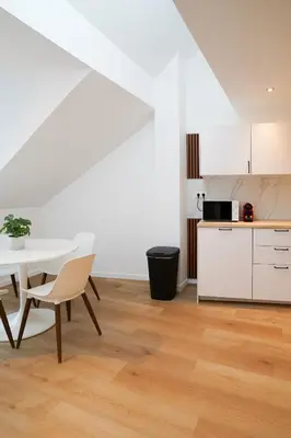 a kitchen and dining room with a table and chairs at Appartment Douvres 7 in Brussels
