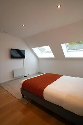 a bedroom with skylights and a bed and a tv at Appartment Douvres 7 in Brussels