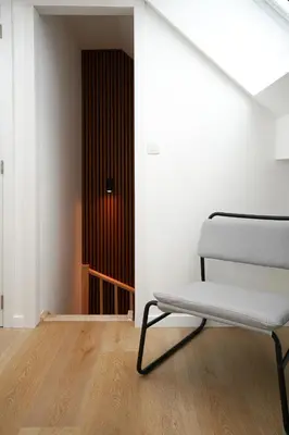a white chair in a room with a door at Appartment Douvres 7 in Brussels