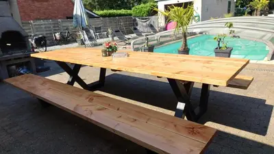 a wooden picnic table and a bench next to a pool at Beach House in Brasschaat