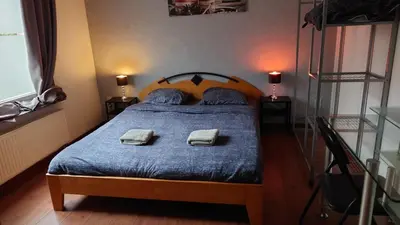 a bedroom with a bed with two towels on it at Beach House in Brasschaat