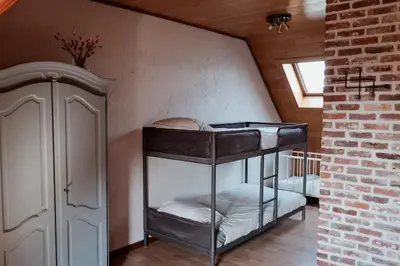 a room with two bunk beds in a attic at Vakantiewoning Welle Weg in Berlare
