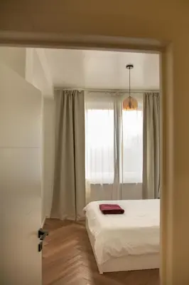 a bedroom with a bed and a window at Brussels South - Cosy Appartment in Brussels