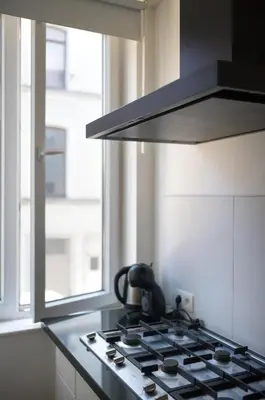 a kitchen with a stove with a tea kettle on it at Brussels South - Cosy Appartment in Brussels