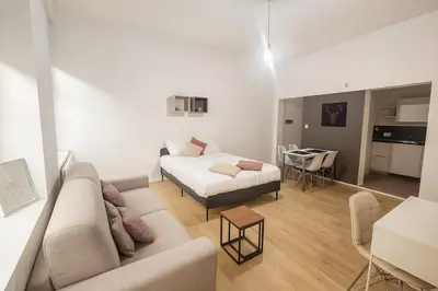 a living room with a couch and a bed at Toison d'Or Apartment in Brussels