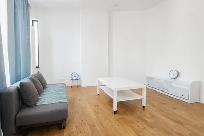 a living room with a couch and a table at Cozy Brabanconne apartment in Brussels