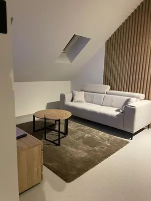 a living room with a white couch and a table at De Kempische Hoef in Westerlo