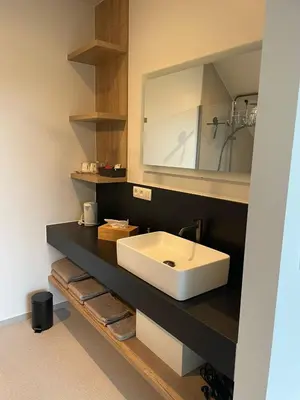 a bathroom with a white sink and a mirror at De Kempische Hoef in Westerlo